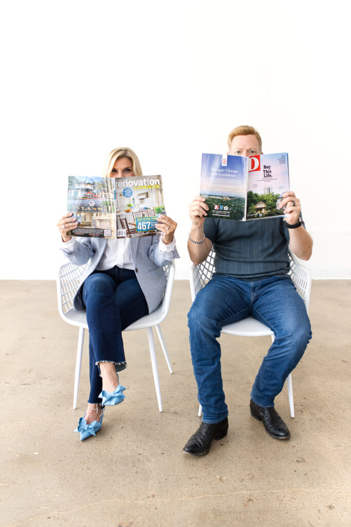 MHR Designs founders seated with magazines, highlighting their blend of Dallas real estate insight and renovation trend awareness.